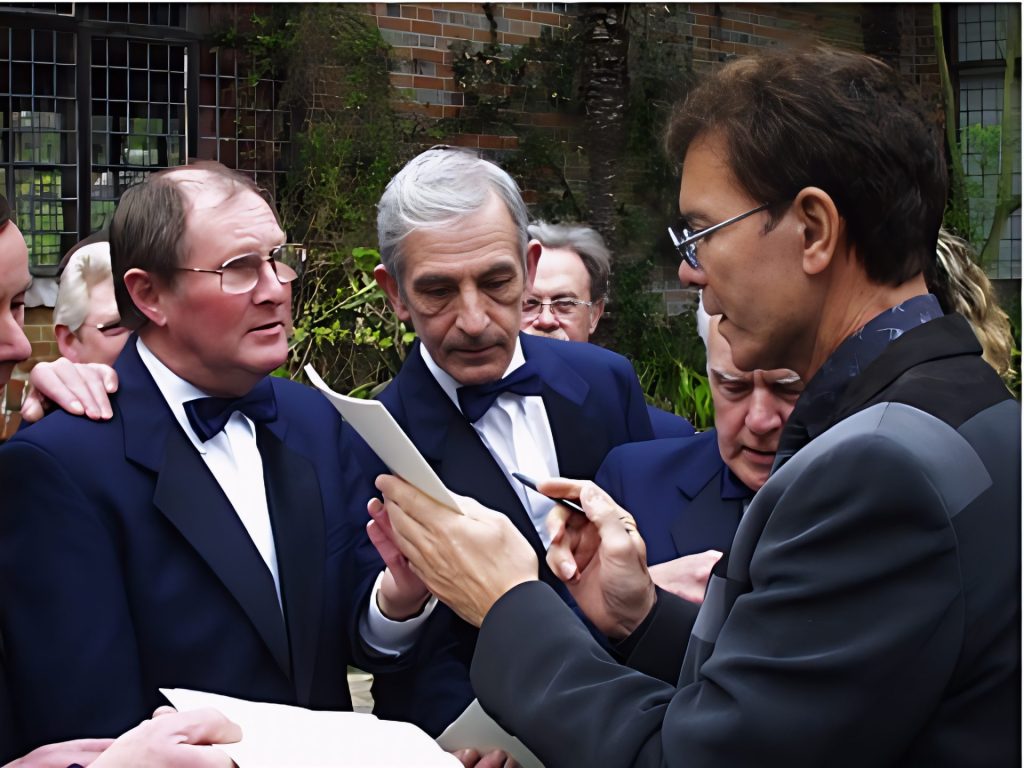 One of the godparents, Sir Cliff Richard, signing autographs for the choir